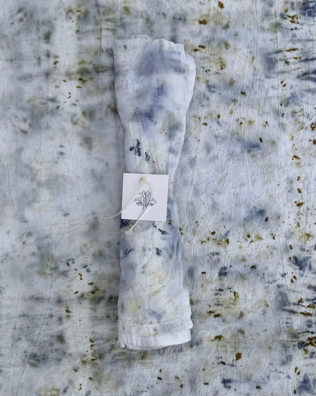 Folded fabric with a tag on a textured surface