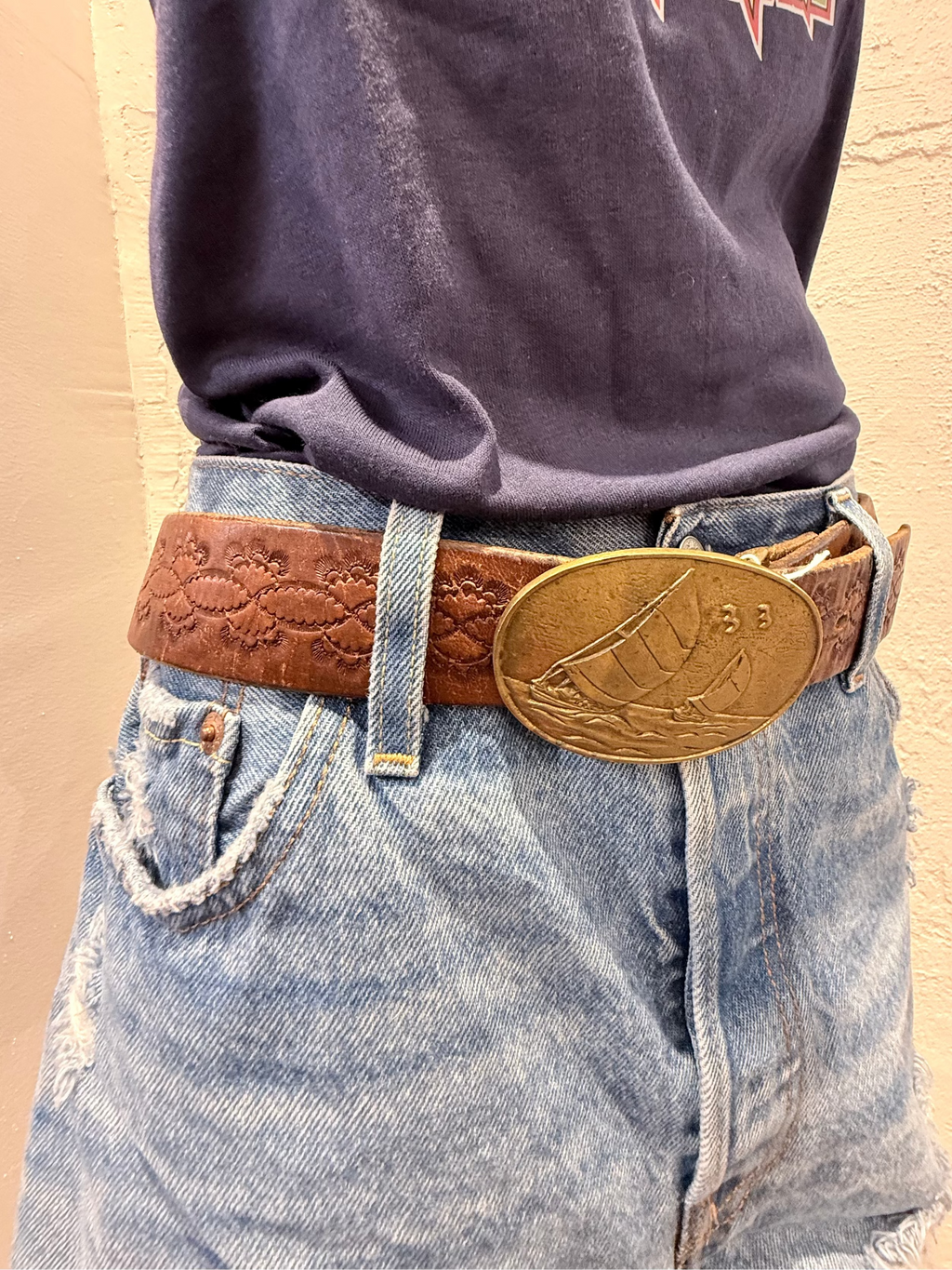 Tooled leather belt with brass sail boat buckle